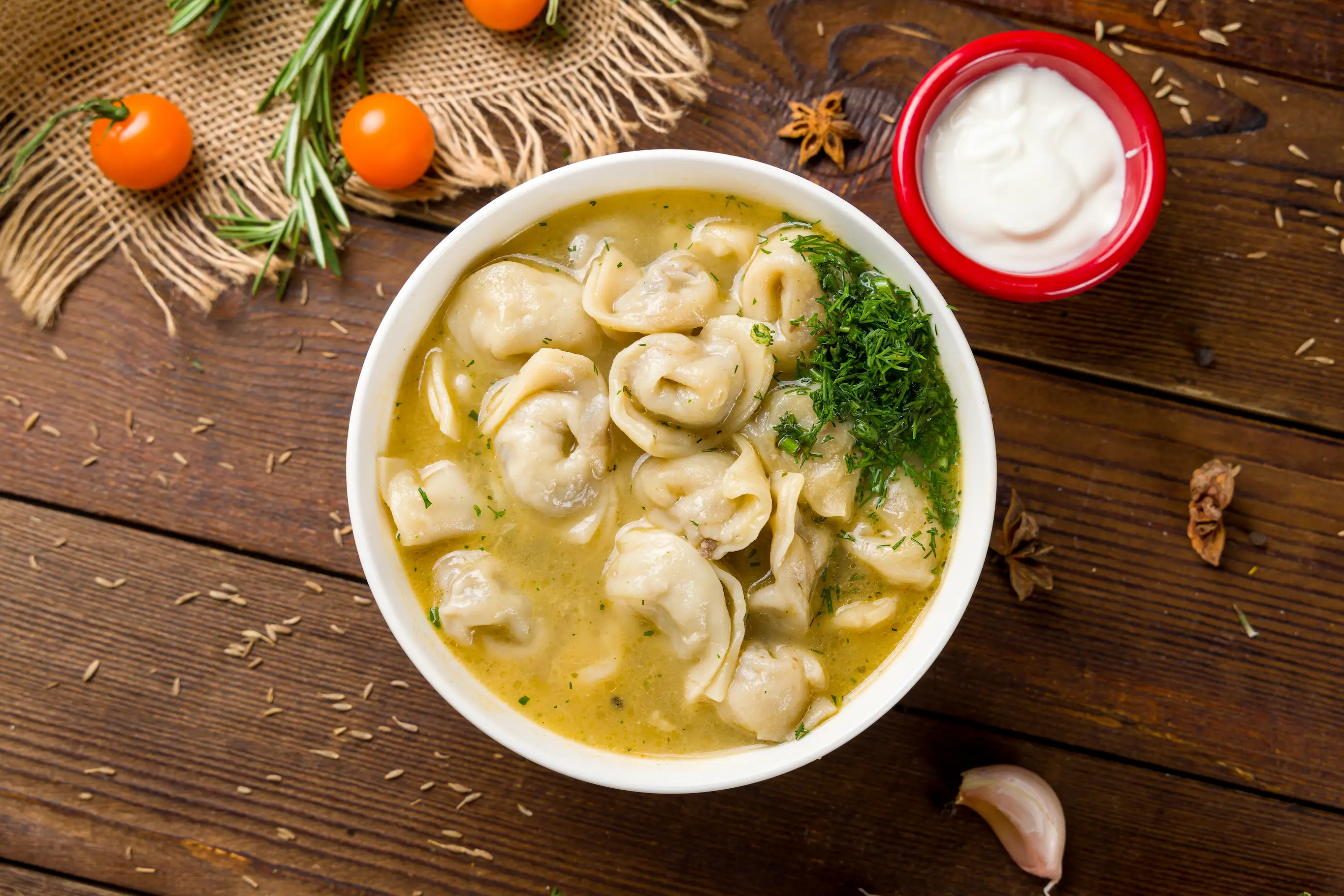 Traditional Azeri dumpling soup Dushbara with yoghurt and greens.