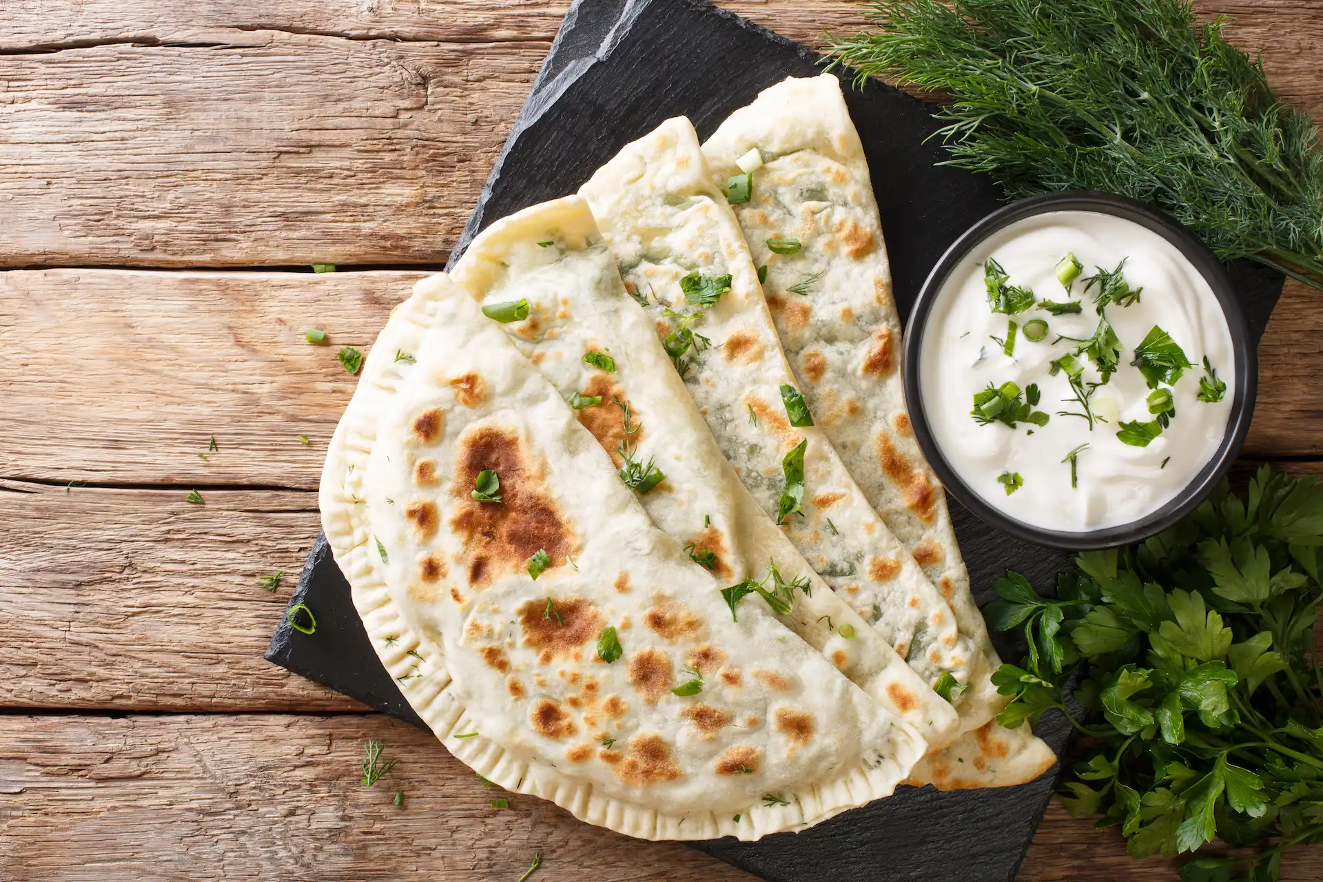 Traditional Azerbaijani Qutab with yoghurt (qatiq) and greens.