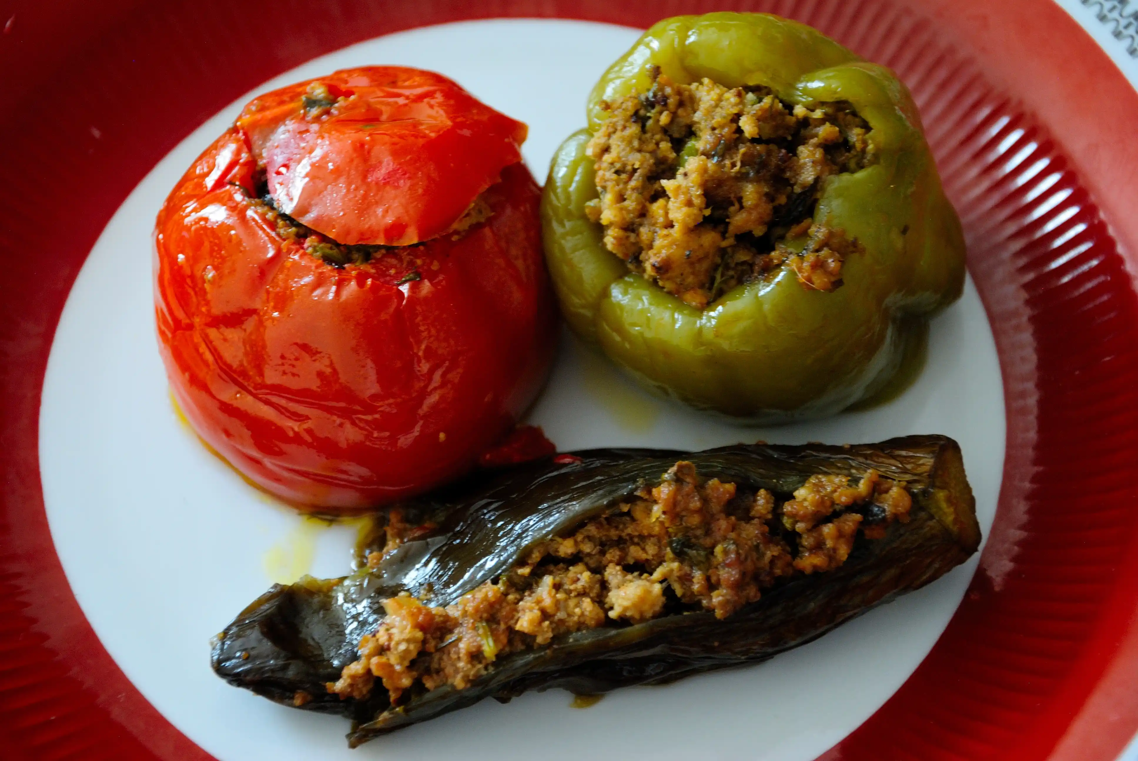 Classical Azerbaijani Three Sisters Dolma with eggplant, tomato, and pepper.