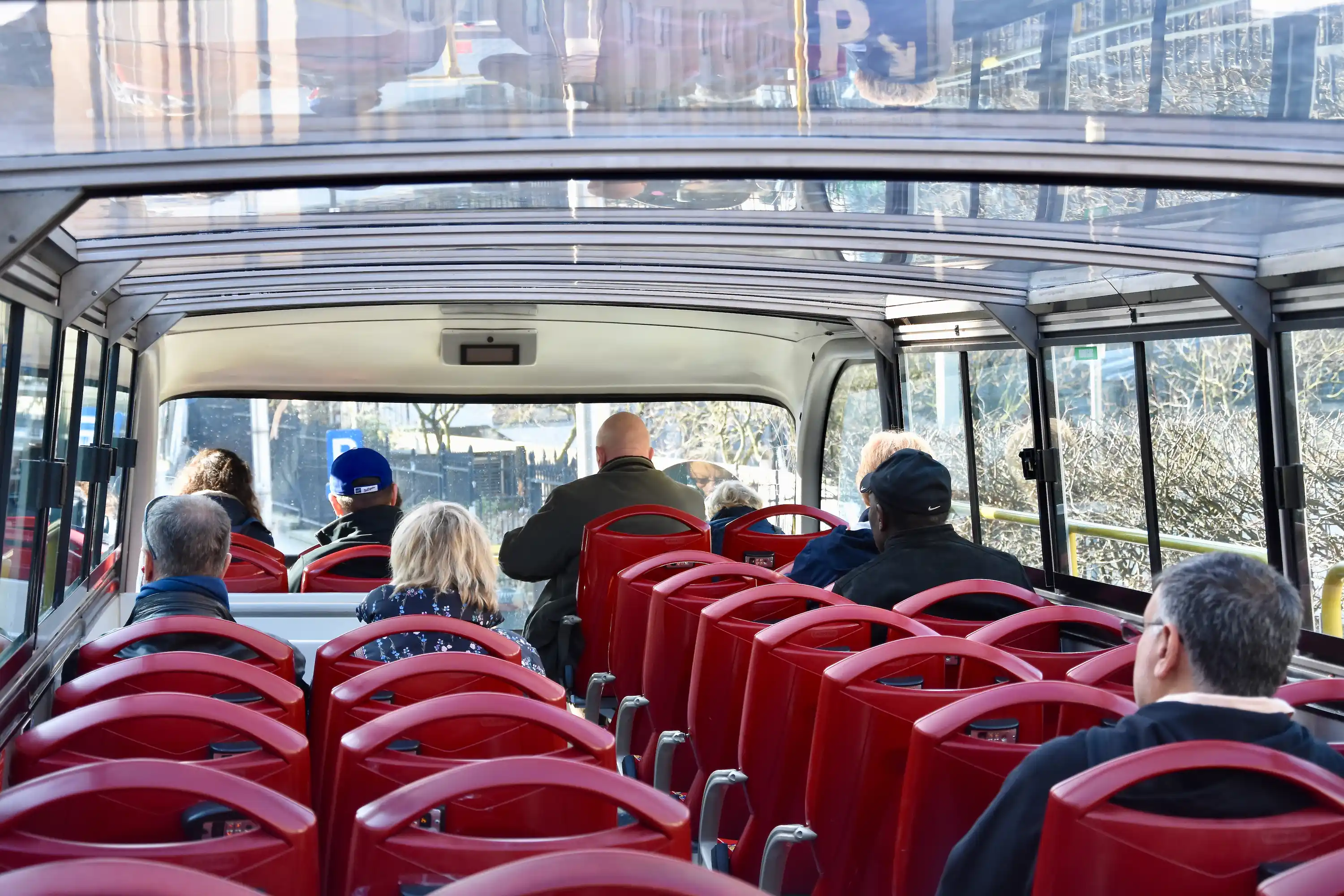 Upper deck interior of the Baku city tour bus with travelers onboard.