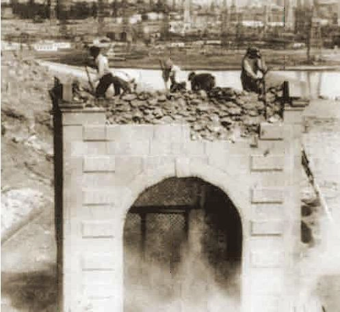 Historic photo showing the destruction of Bibi Heybat Mosque by the Soviets in 1936 with workers on top of the structure.