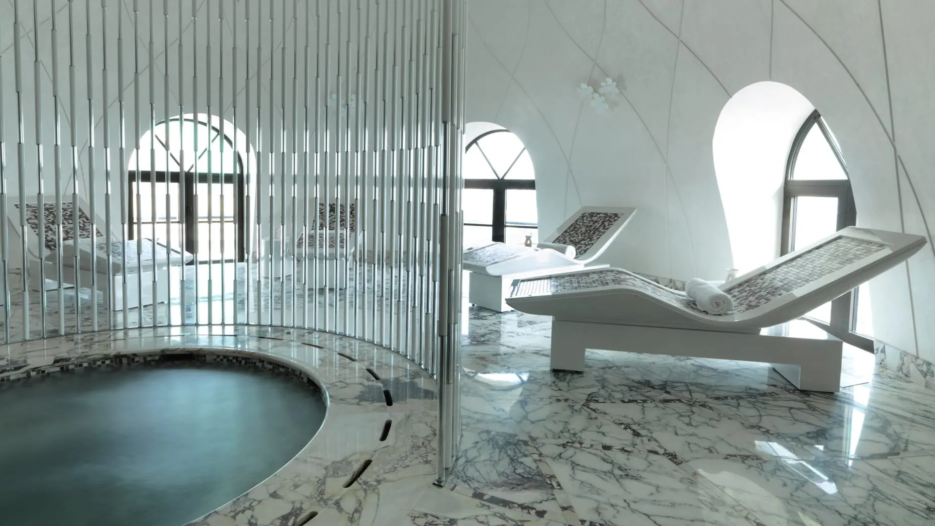 The indoor spa at Four Seasons Hotel Baku with heated lounge chairs and a whirlpool.