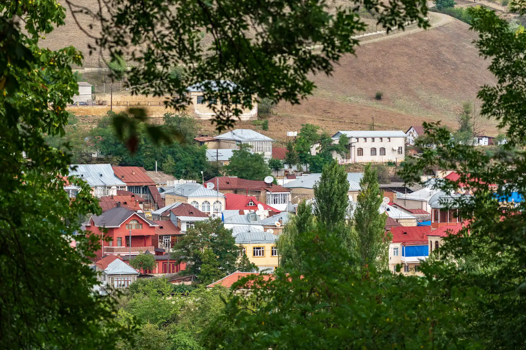 Krasnaya Sloboda in Quba, Azerbaijan, with its red-roofed buildings among trees.