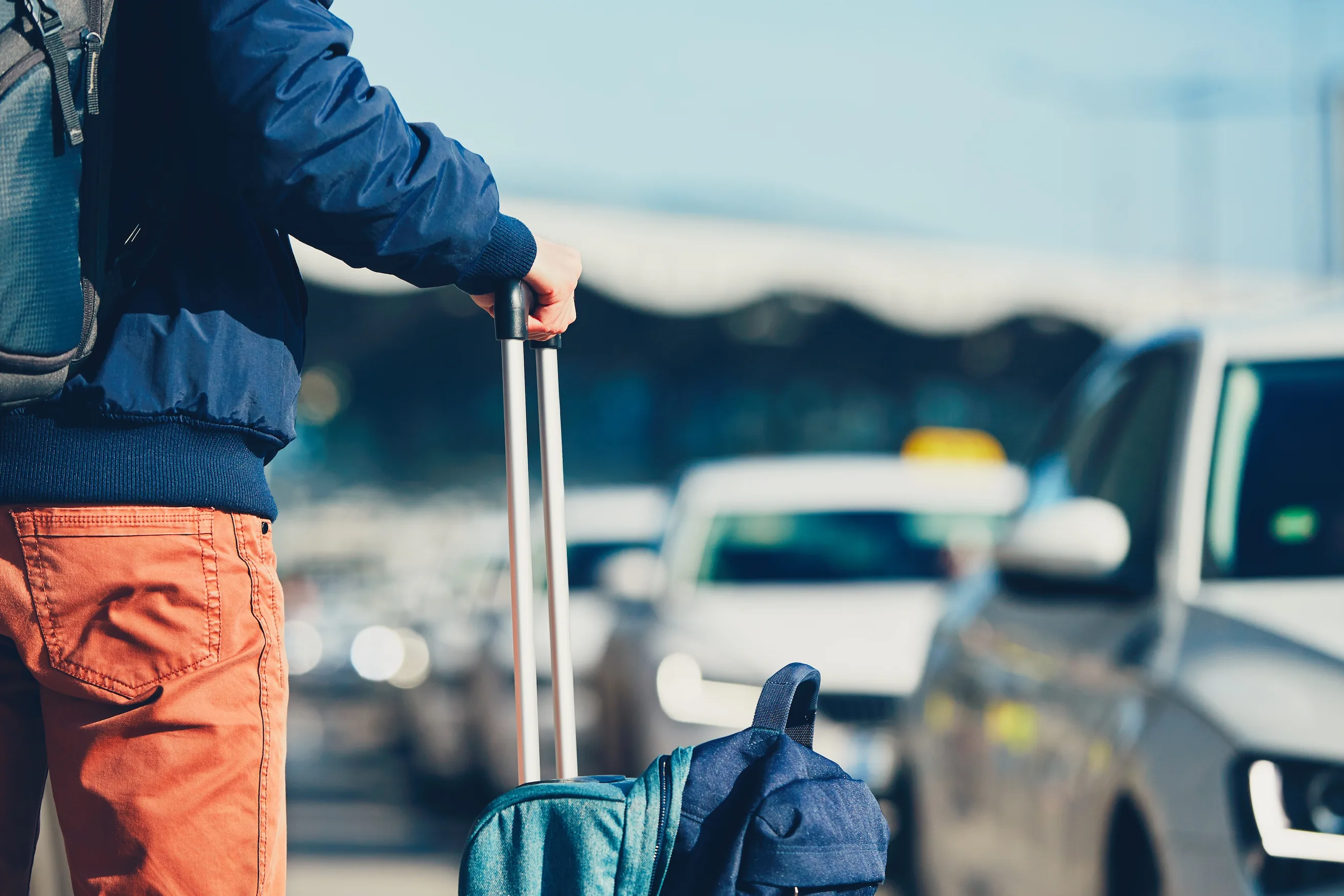 Passenger waiting for a traditional taxi at GYD Airport.