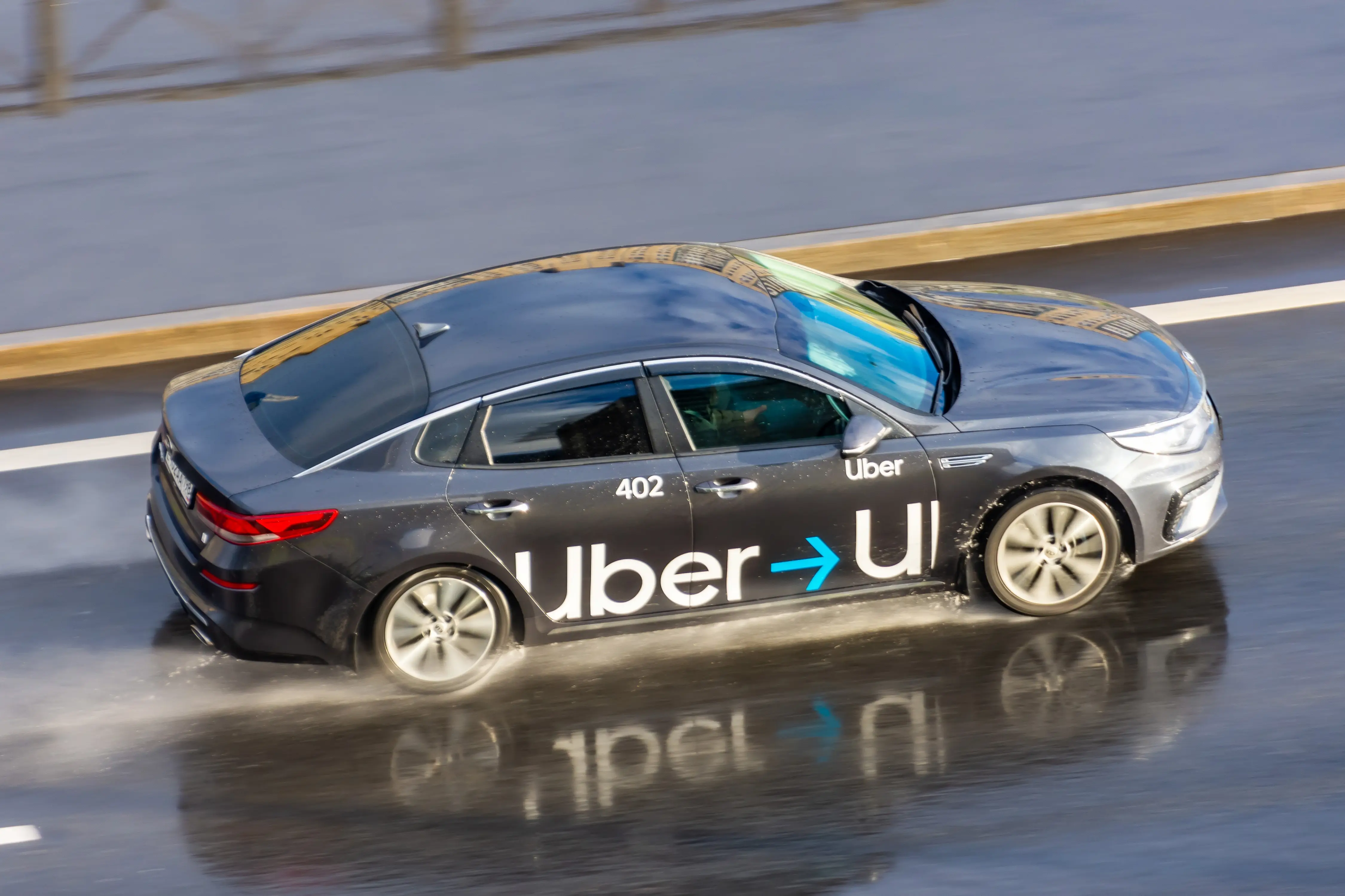 Taxi car of Uber Azerbaijan driving on a rainy day.