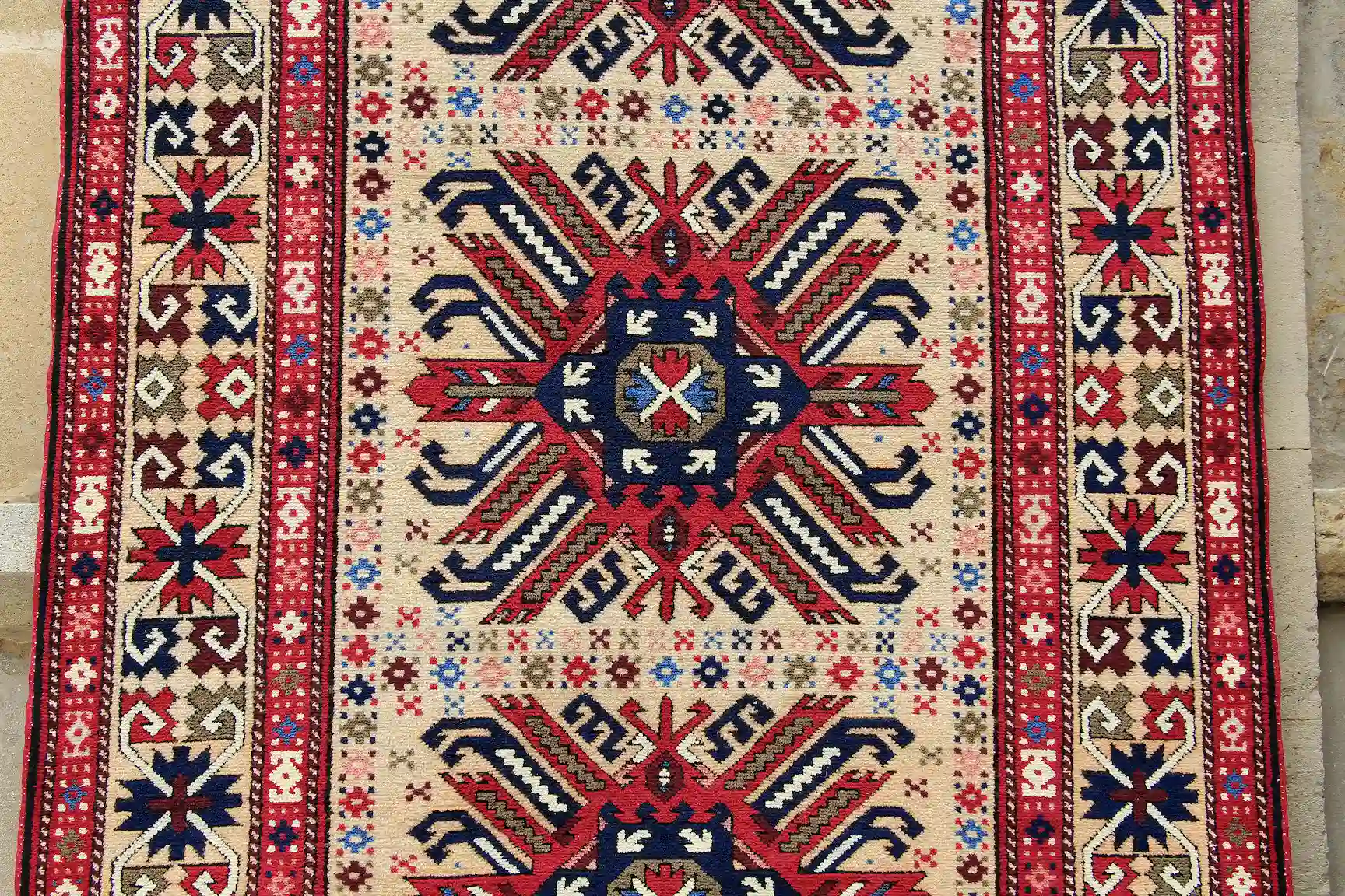 Flat-woven Azeri carpet with red, white, and black ornaments.