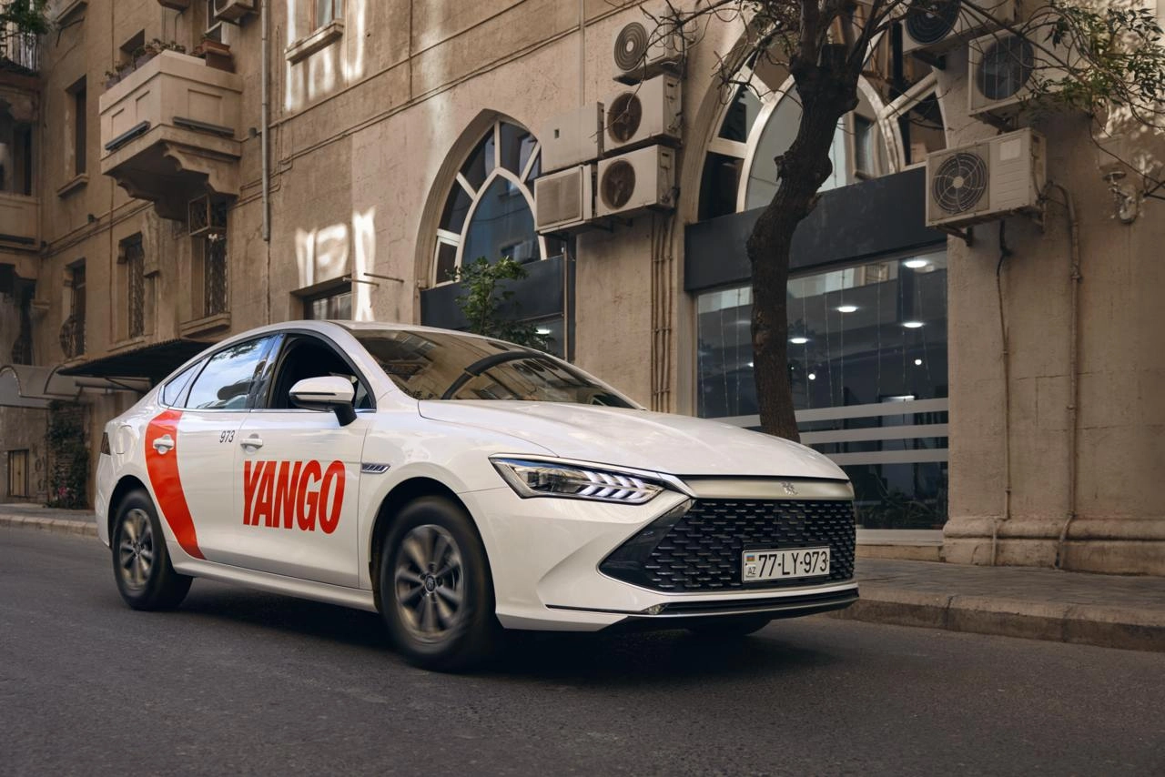 Yango taxi of Azerbaijan parked in front of a residential building.