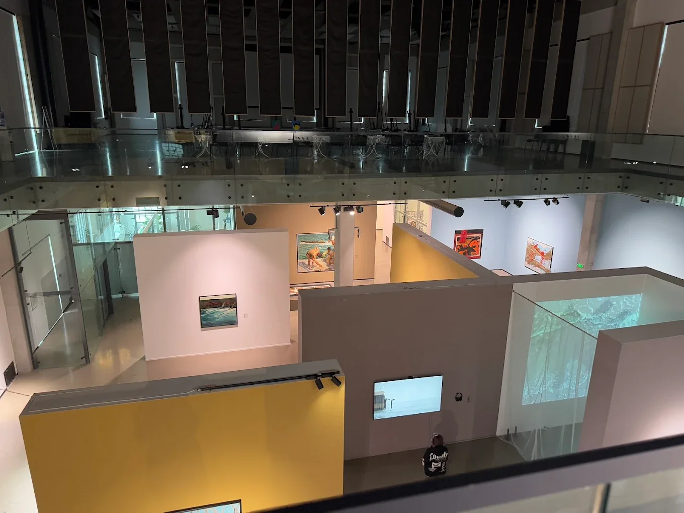 The interior of YARAT Contemporary Art Space in Baku features modern gallery rooms with colorful artworks, glass architecture, and open exhibition layouts.